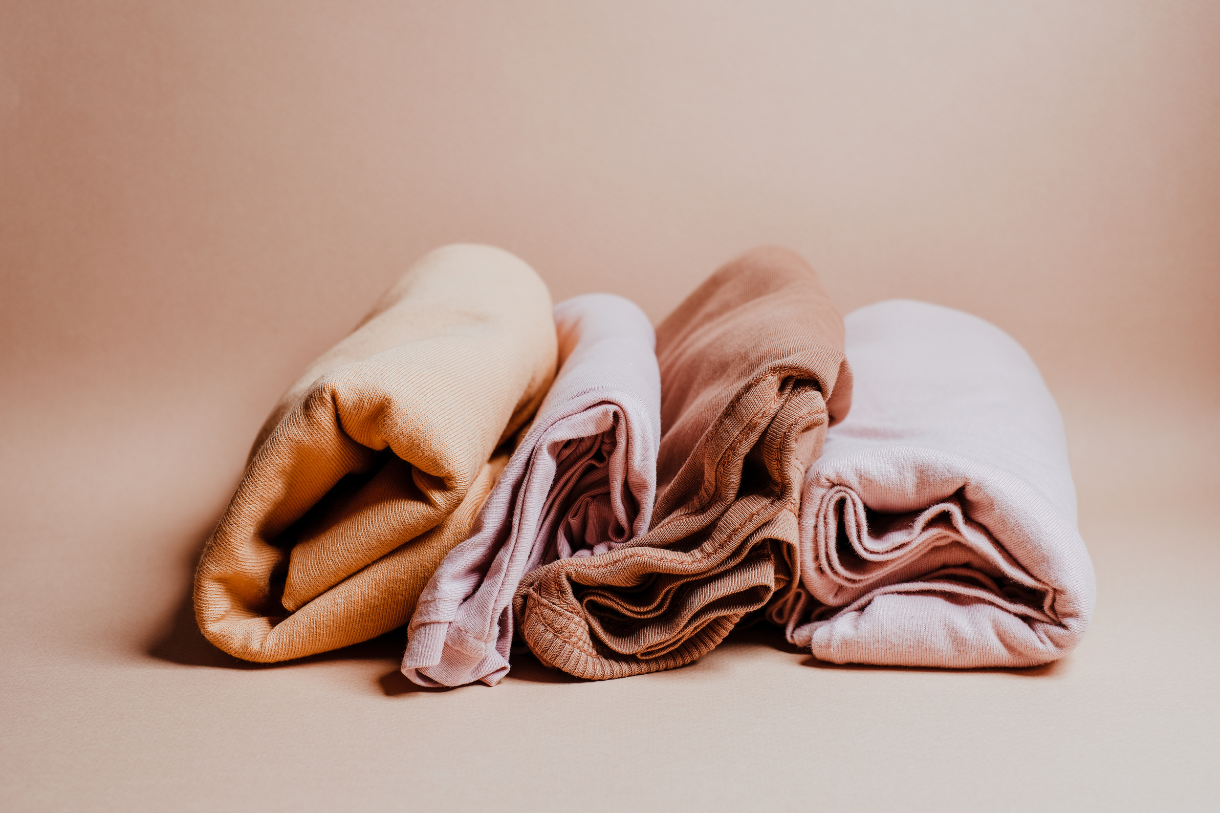 Folded Clothes on Beige Background